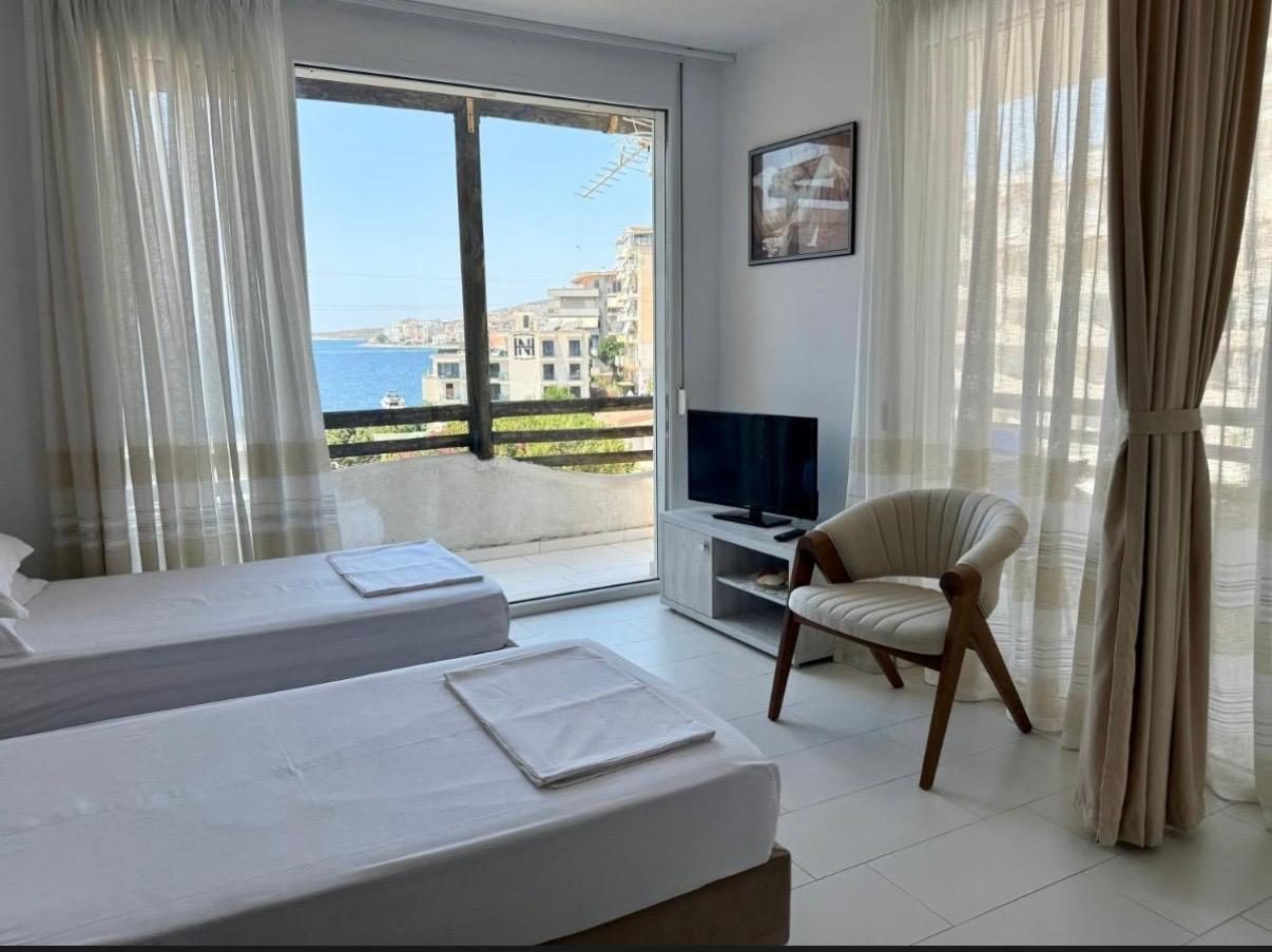 Twin bedroom with a balcony overlooking Saranda bay
